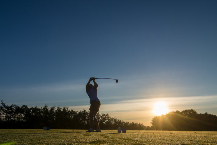 golfing in sunset